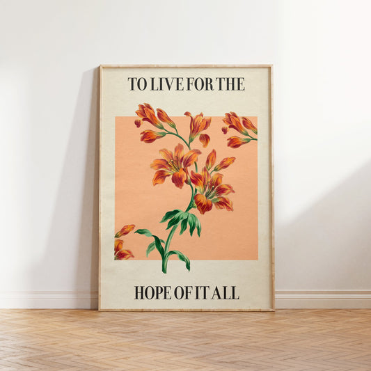 For The Hope Of It All Taylor Swift print of orange lilies on a peach square, framed, leaning against a white wall