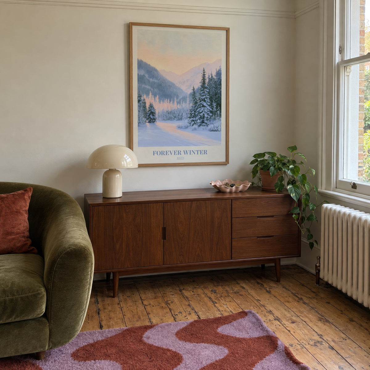 Forever Winter Taylor Swift print of snowy pines in a mountain valley, hung above a mid-century sideboard