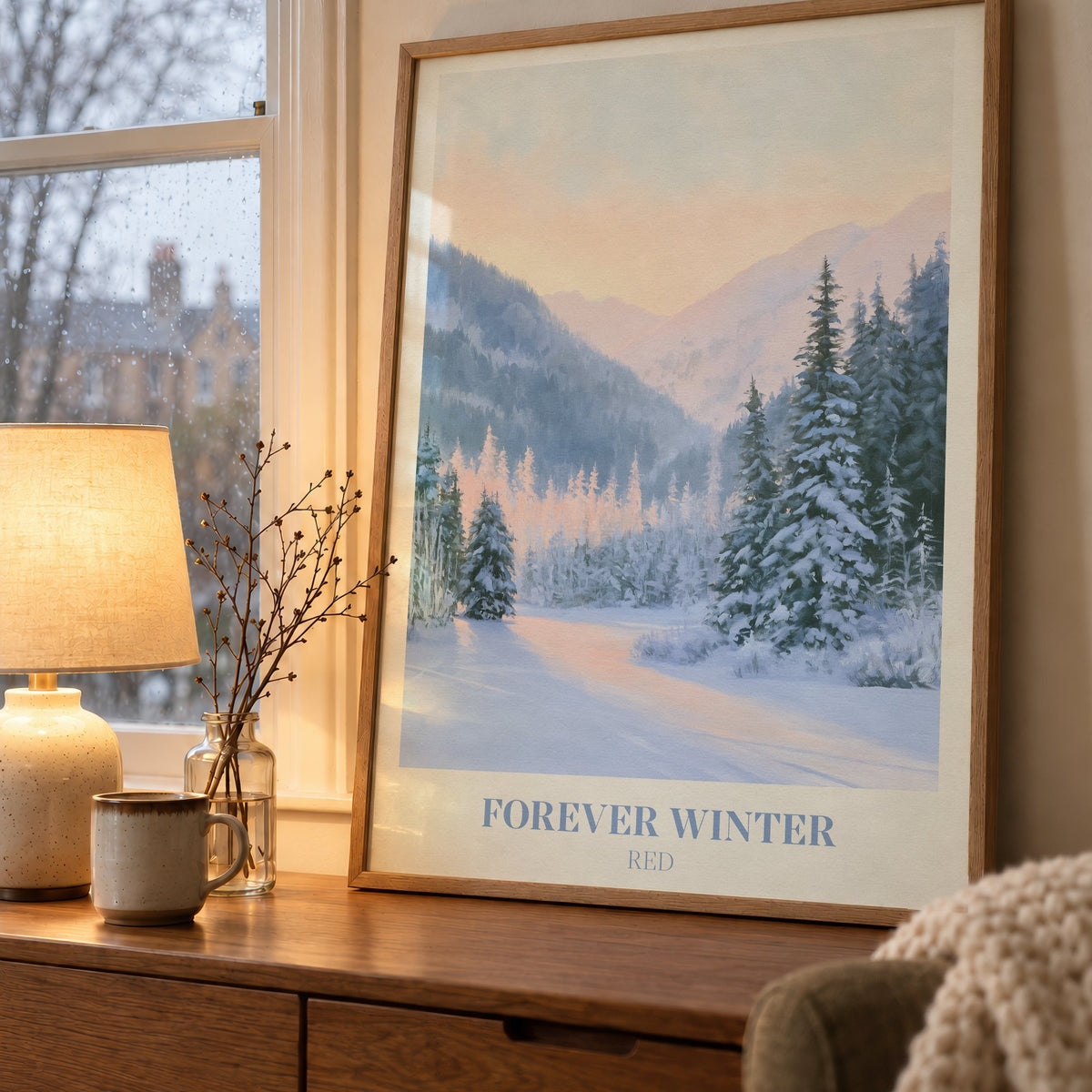 Forever Winter Taylor Swift print of snowy pines in a mountain valley, on a wooden sideboard by a rainy window