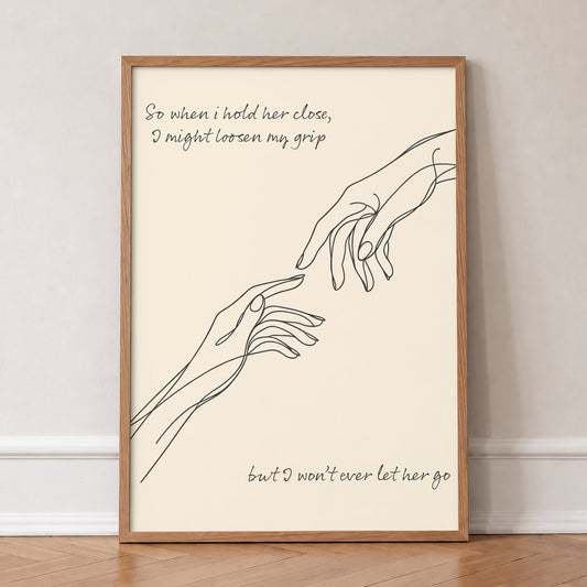 Forever Noah Kahan lyric print, a line drawing of two hands reaching out, in an oak frame, leaning against a wall on a herringbone floor