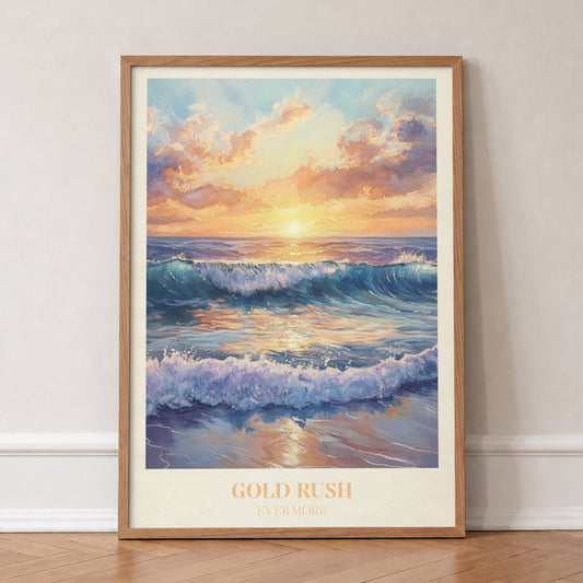Gold Rush Taylor Swift print of waves breaking on a beach under a golden sunset, in an oak frame, leaning against a wall on a herringbone floor