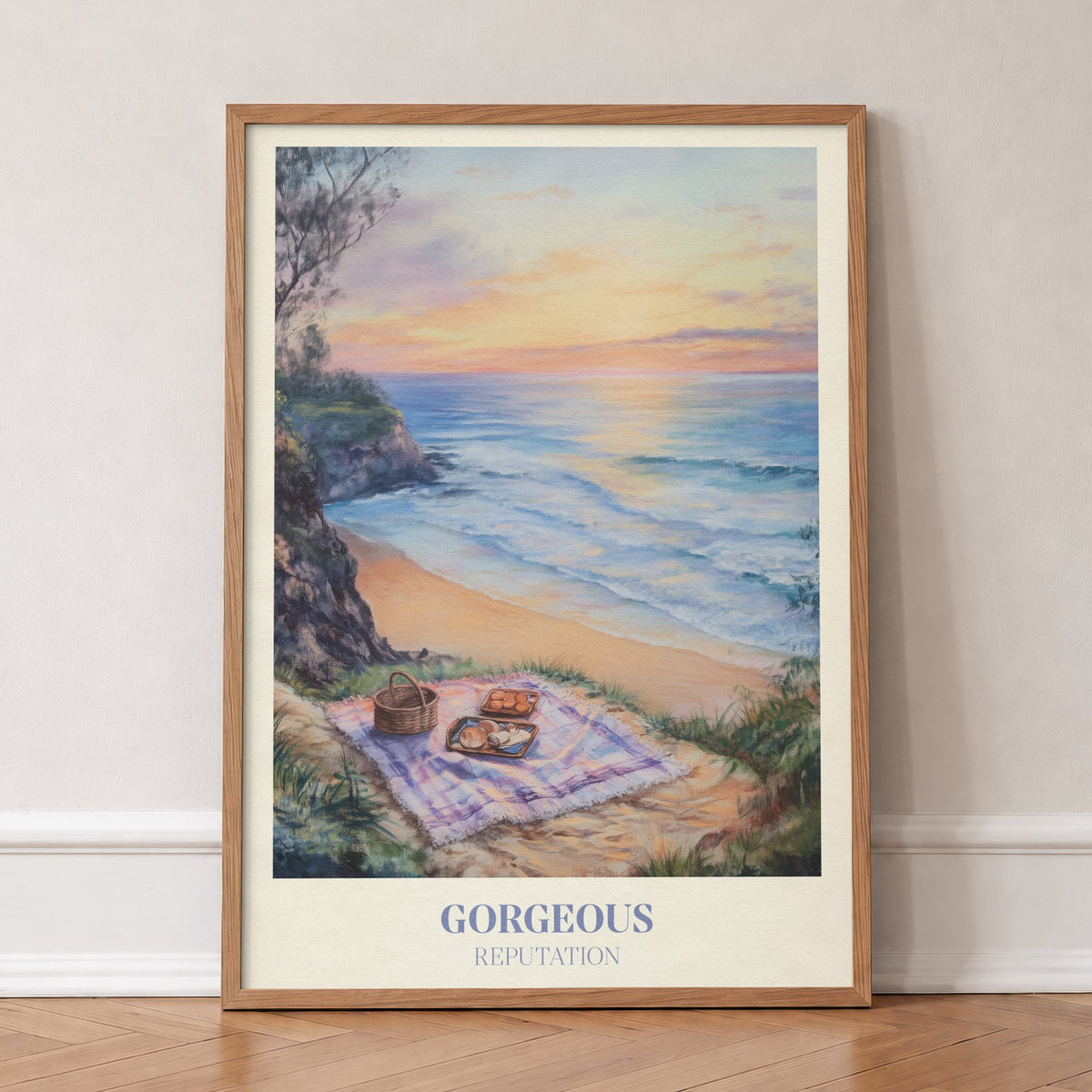 Gorgeous Taylor Swift print of a picnic blanket and basket on a clifftop above the sea at sunset, in an oak frame, leaning against a wall on a herringbone floor