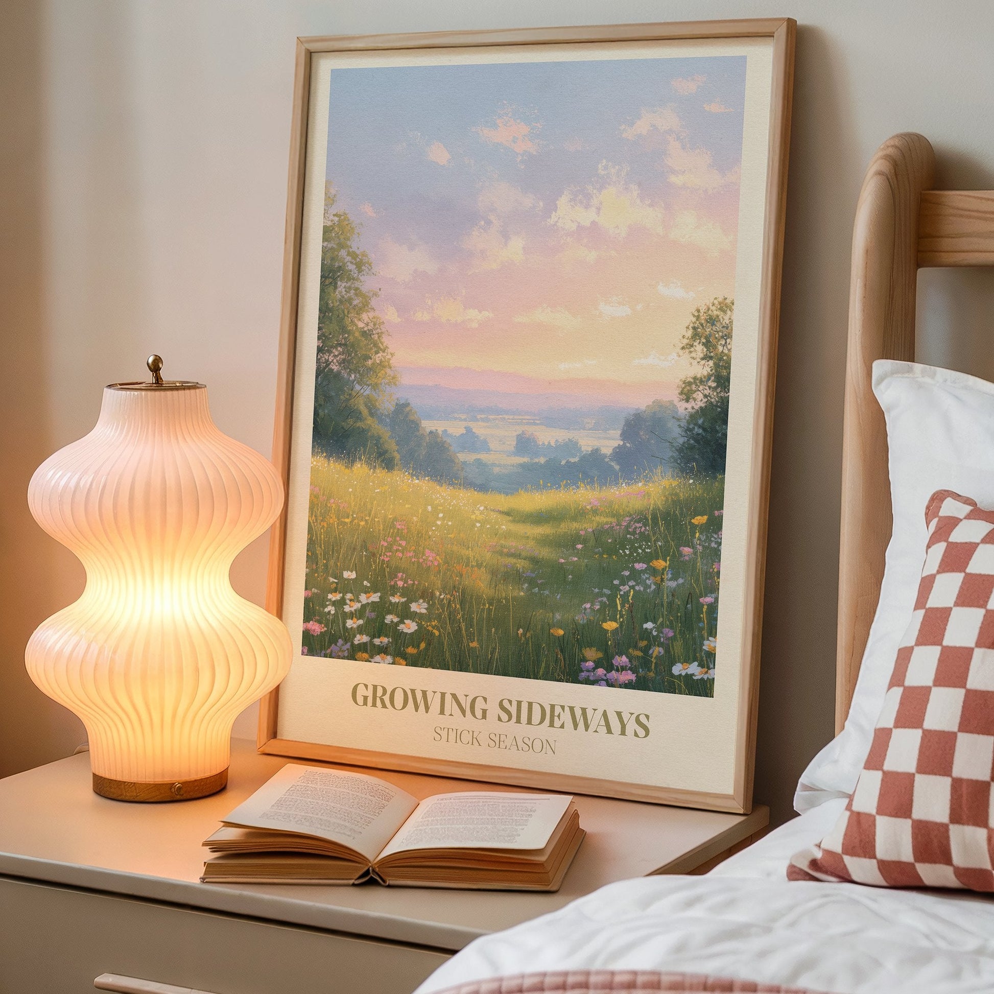 Growing Sideways lyric wall art print inspired by Noah Kahan on a bedside table next to a lamp