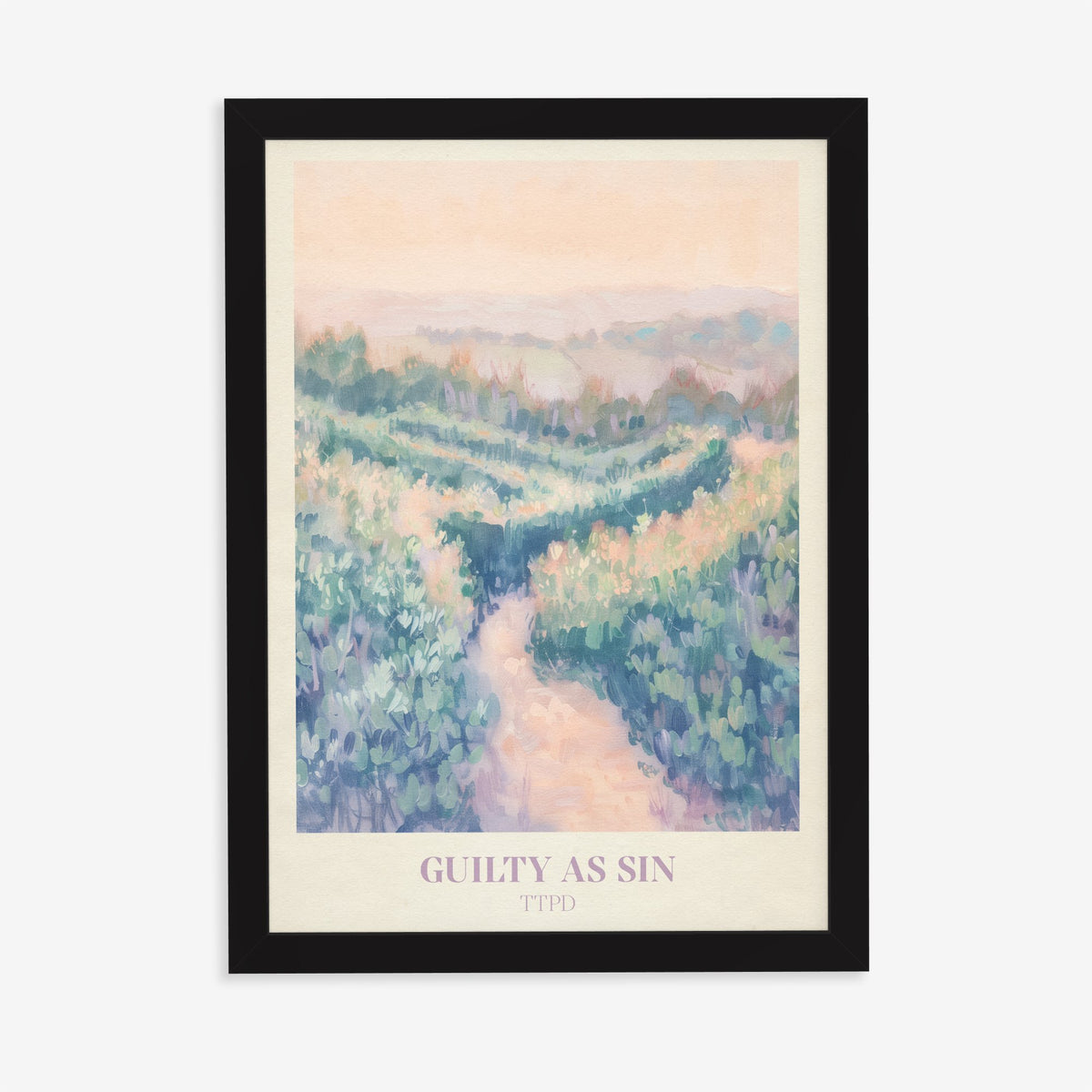 Guilty As Sin Taylor Swift print of a winding path through pastel green hills under a peach sky, in a black frame on a plain wall
