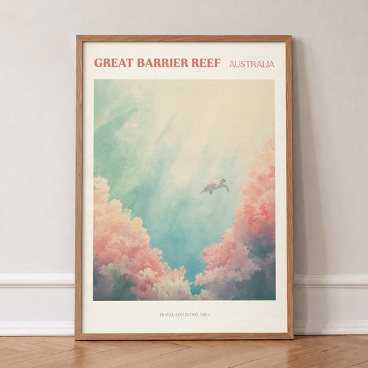 Great Barrier Reef travel print of a sea turtle swimming above pink coral in turquoise water, in an oak frame, leaning against a wall on a herringbone floor