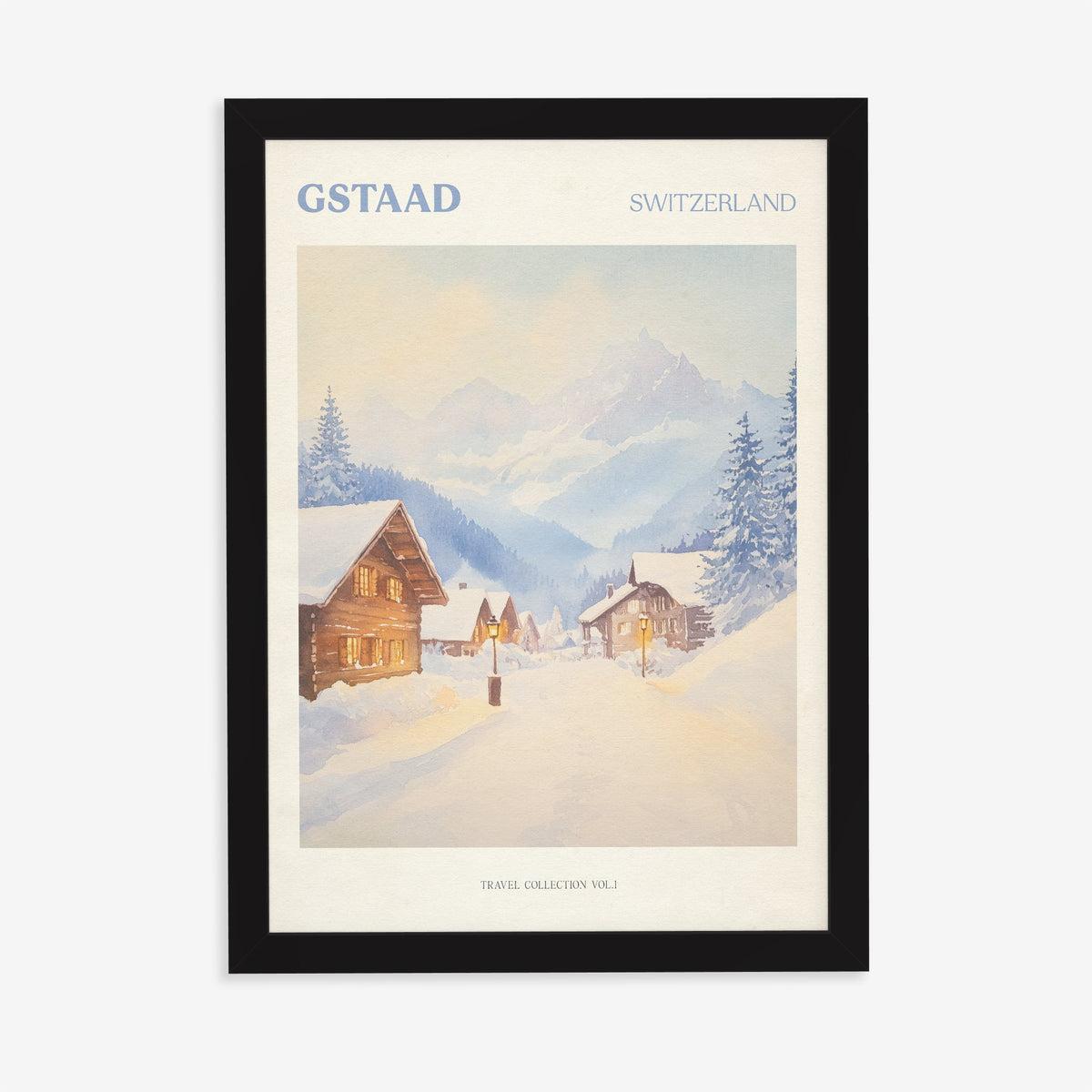 Gstaad travel print of snow-covered wooden chalets and pine trees below the Swiss Alps, in a black frame on a plain wall