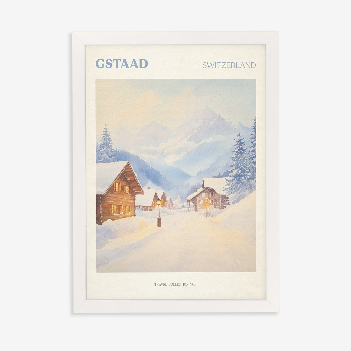 Gstaad travel print of snow-covered wooden chalets and pine trees below the Swiss Alps, in a white frame on a plain wall