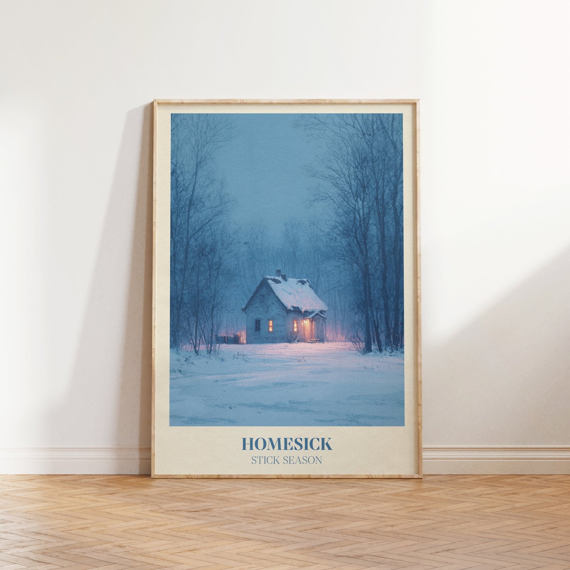 Homesick lyric wall art print inspired by Noah Kahan leaning against a white wall on a wooden herringbone floor in soft daylight