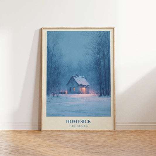 Homesick lyric wall art print inspired by Noah Kahan leaning against a white wall on a wooden herringbone floor in soft daylight