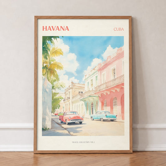 Havana travel print of pastel pink and mint buildings with classic cars parked outside, in an oak frame, leaning against a wall on a herringbone floor