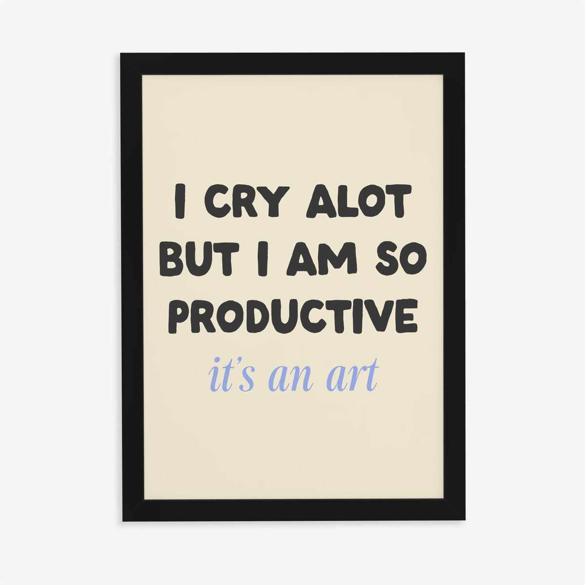 I Cry A Lot But I’m So Productive Taylor Swift lyric print of black and blue lettering on cream, in a black frame on a plain wall