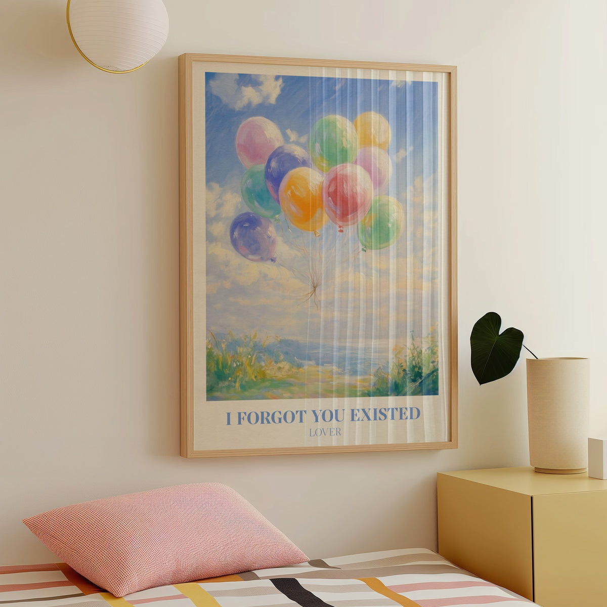 I Forgot You Existed Taylor Swift print of pastel balloons floating over the sea, framed above a bed
