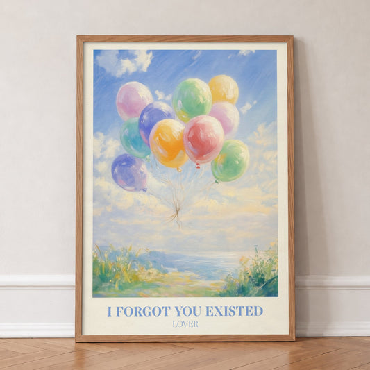 I Forgot You Existed Taylor Swift print of pastel balloons floating over the sea, in an oak frame, leaning against a wall on a herringbone floor
