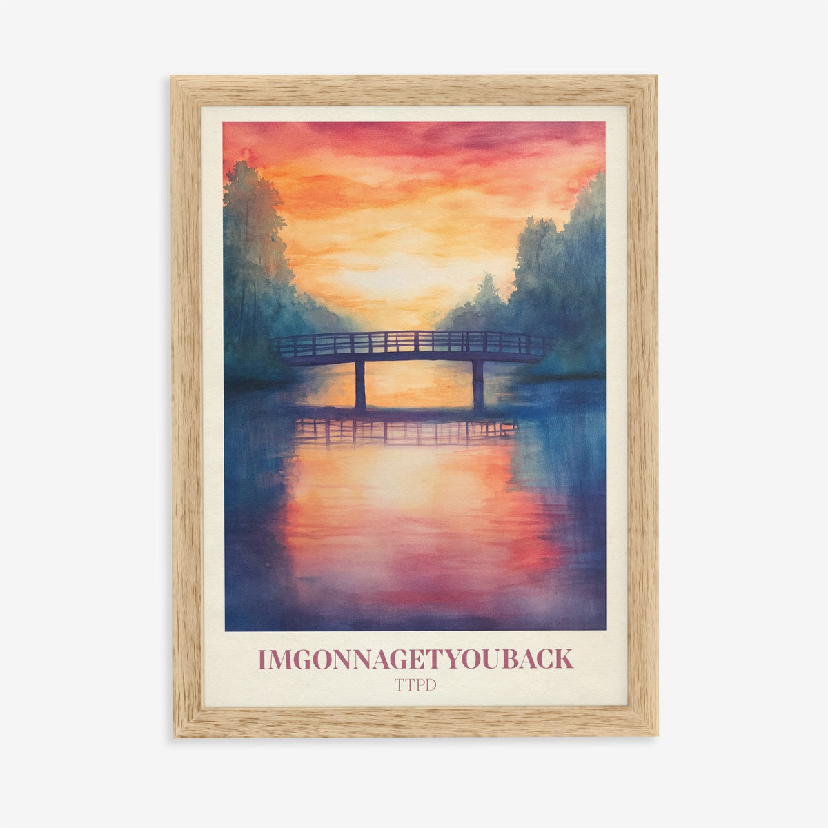 Imgonnagetyouback Taylor Swift print of a footbridge over a river at a fiery sunset, in an oak frame on a plain wall