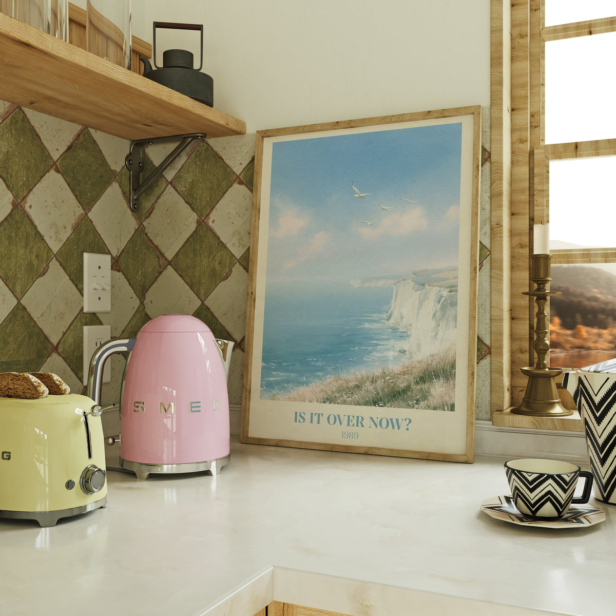 Is It Over Now? Taylor Swift print of white cliffs above a blue sea, on a kitchen counter beside a kettle and toaster