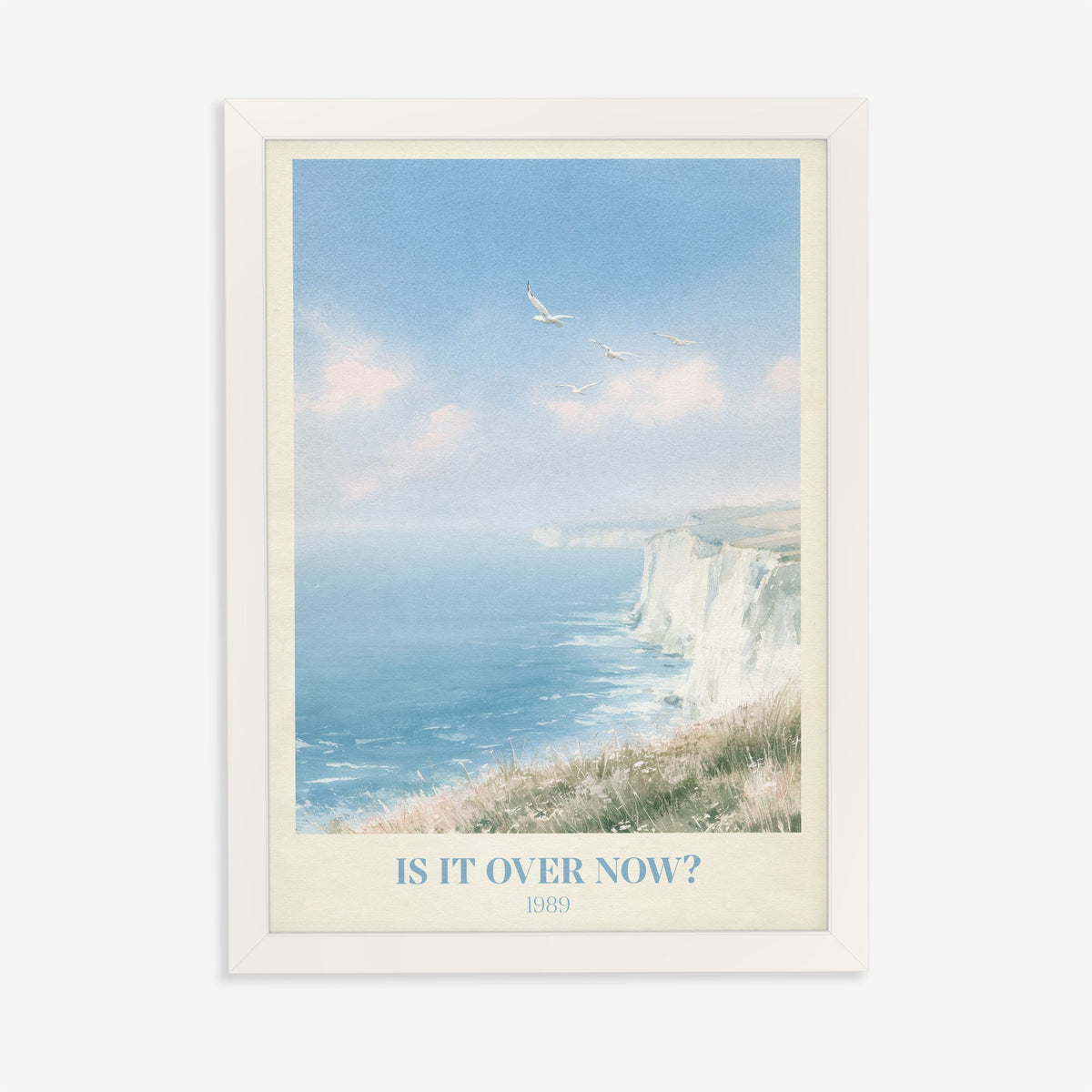 Is It Over Now? Taylor Swift print of white cliffs above a blue sea, in a white frame on a plain wall