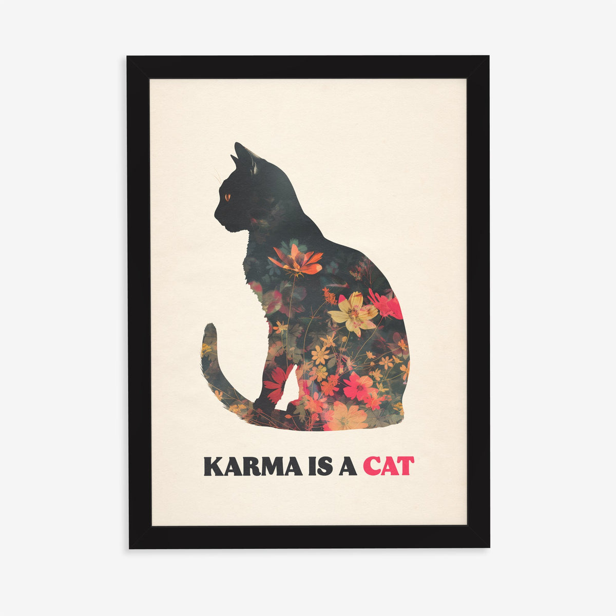 Karma Is A Cat Taylor Swift print of a black cat silhouette filled with red and orange flowers, in a black frame on a plain wall
