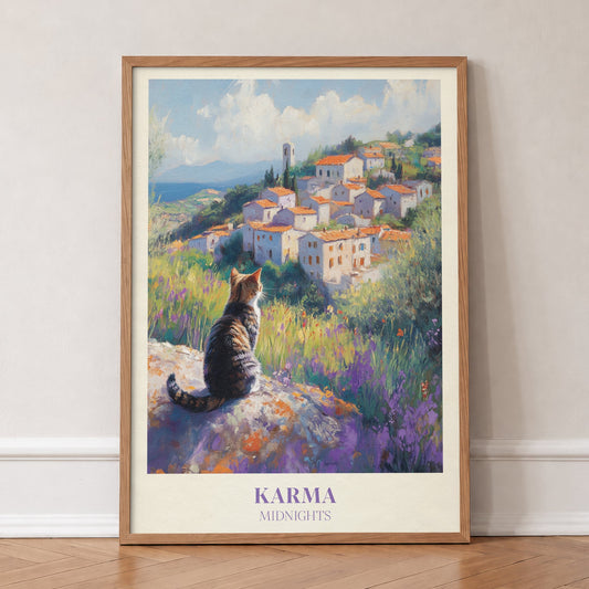 Karma Taylor Swift print of a tabby cat looking out over a hilltop village and lavender, in an oak frame, leaning against a wall on a herringbone floor