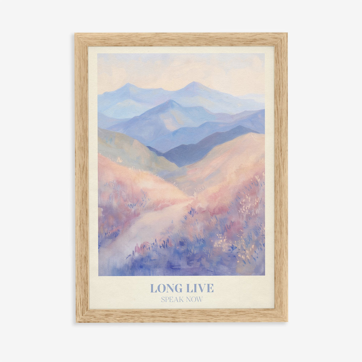Long Live Taylor Swift print of rolling lavender and blue mountains, in an oak frame on a plain wall