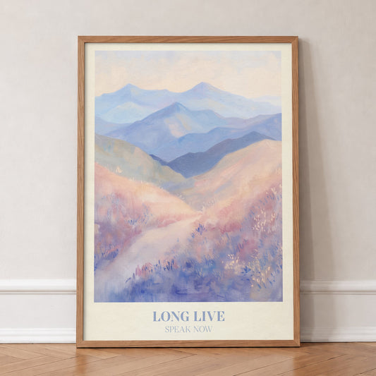 Long Live Taylor Swift print of rolling lavender and blue mountains, in an oak frame, leaning against a wall on a herringbone floor