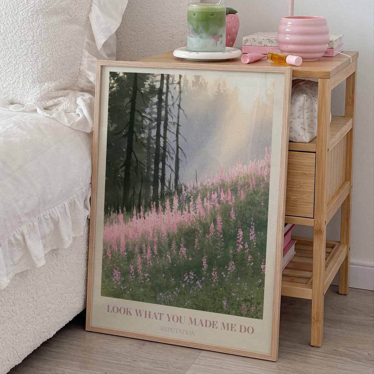 Look What You Made Me Do Taylor Swift print of pink wildflowers by pines, leaning beside a bed and a bamboo nightstand