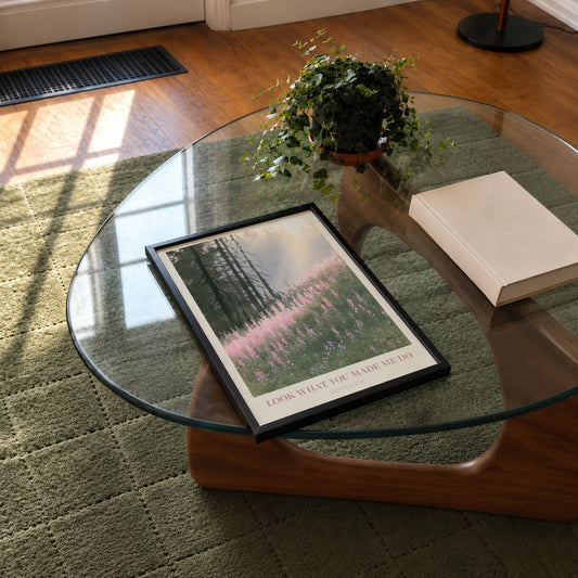 Look What You Made Me Do Taylor Swift print of pink wildflowers by pines, on a glass coffee table