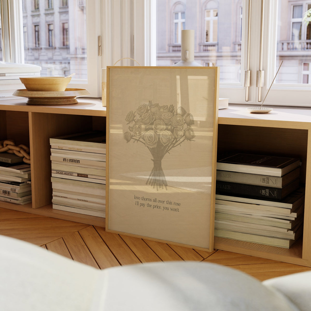 Love Thorns All Over Taylor Swift print of a sketched bunch of roses on cream paper, framed on a bookcase by a window