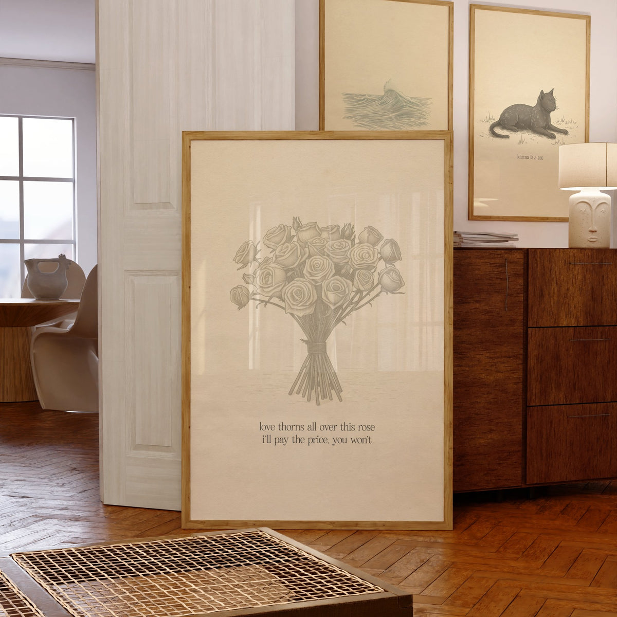 Love Thorns All Over Taylor Swift print of a sketched bunch of roses on cream paper, framed, leaning against a chest of drawers