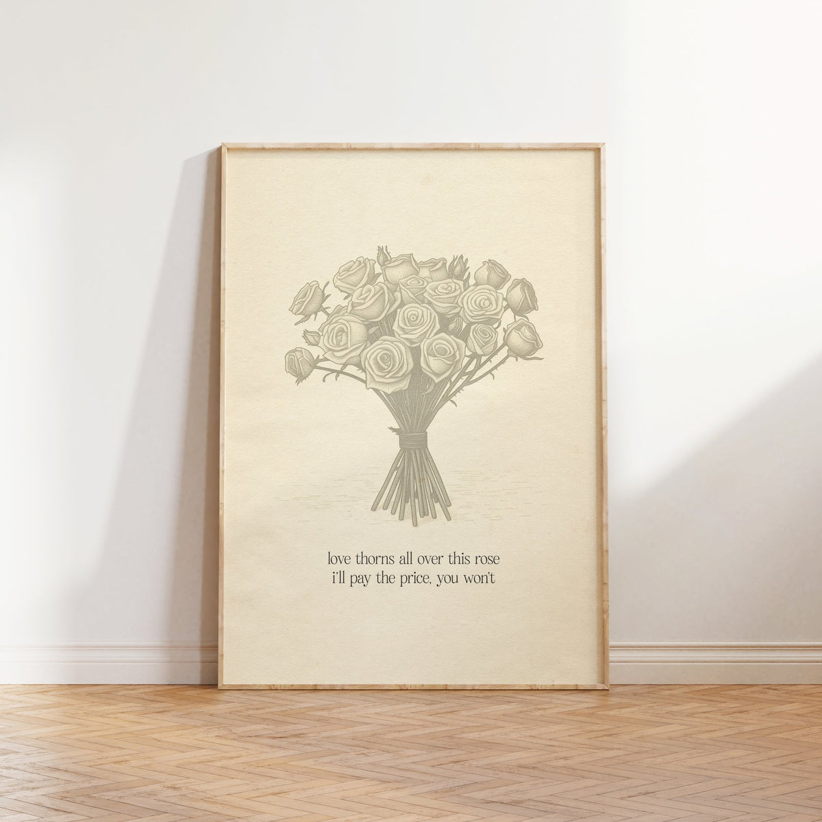 Love Thorns All Over Taylor Swift print of a sketched bunch of roses on cream paper, framed, leaning against a white wall