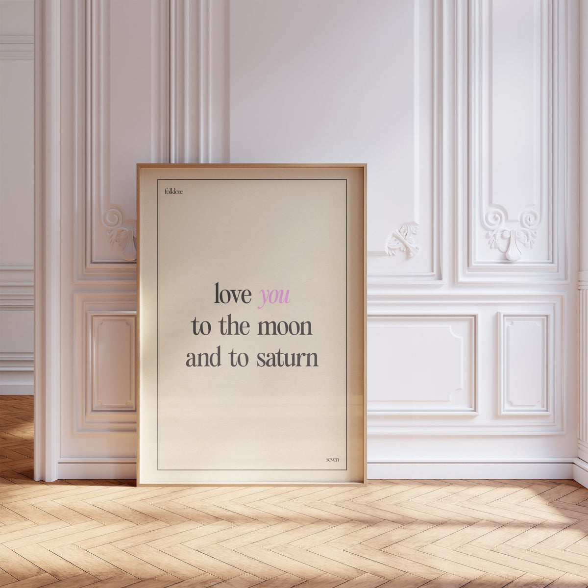 Love You To The Moon Taylor Swift print of the lyric in black and pink type on cream, framed, leaning against a white panelled wall