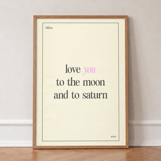 Love You To The Moon Taylor Swift print of the lyric in black and pink type on cream, in an oak frame, leaning against a wall on a herringbone floor