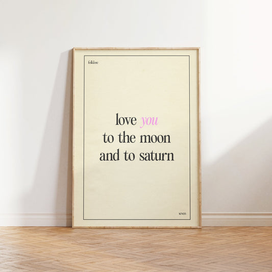 Love You To The Moon Taylor Swift print of the lyric in black and pink type on cream, framed, leaning against a white wall