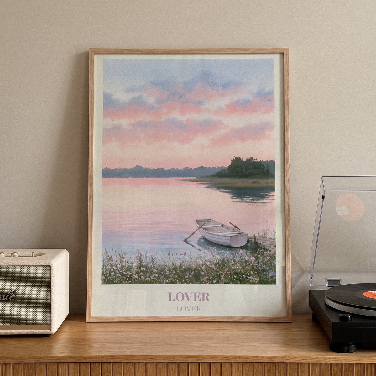 Lover Taylor Swift print of a rowing boat on a pink lake, on a sideboard beside a record player