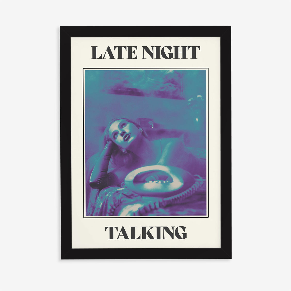 Late Night Talking Harry Styles print of a retro purple and teal phone photo, in a black frame on a plain wall