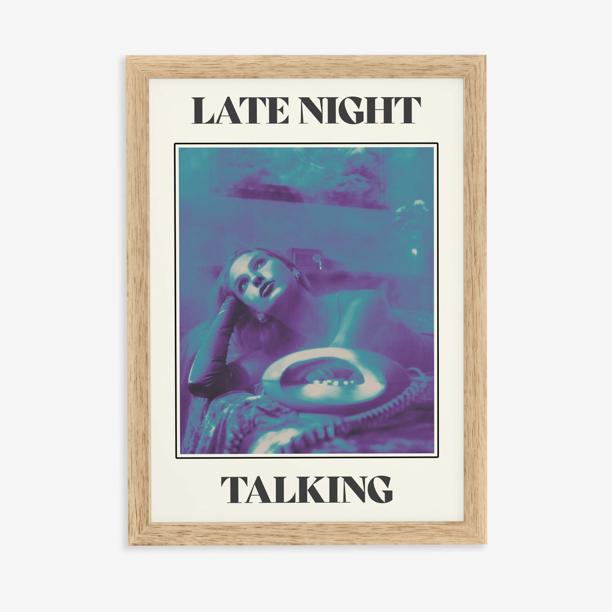 Late Night Talking Harry Styles print of a retro purple and teal phone photo, in an oak frame on a plain wall