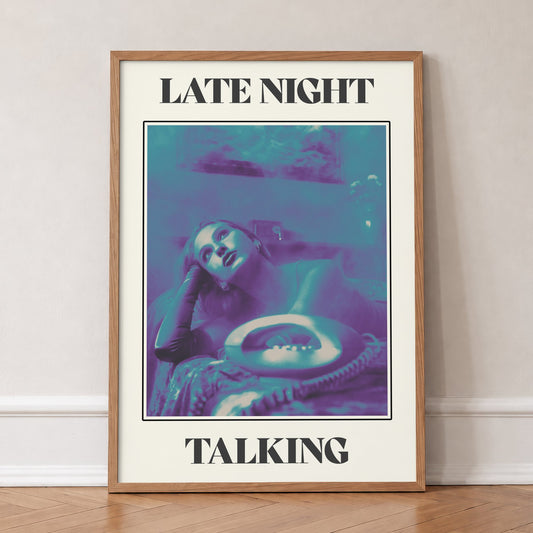 Late Night Talking Harry Styles print of a retro purple and teal phone photo, in an oak frame, leaning against a wall on a herringbone floor