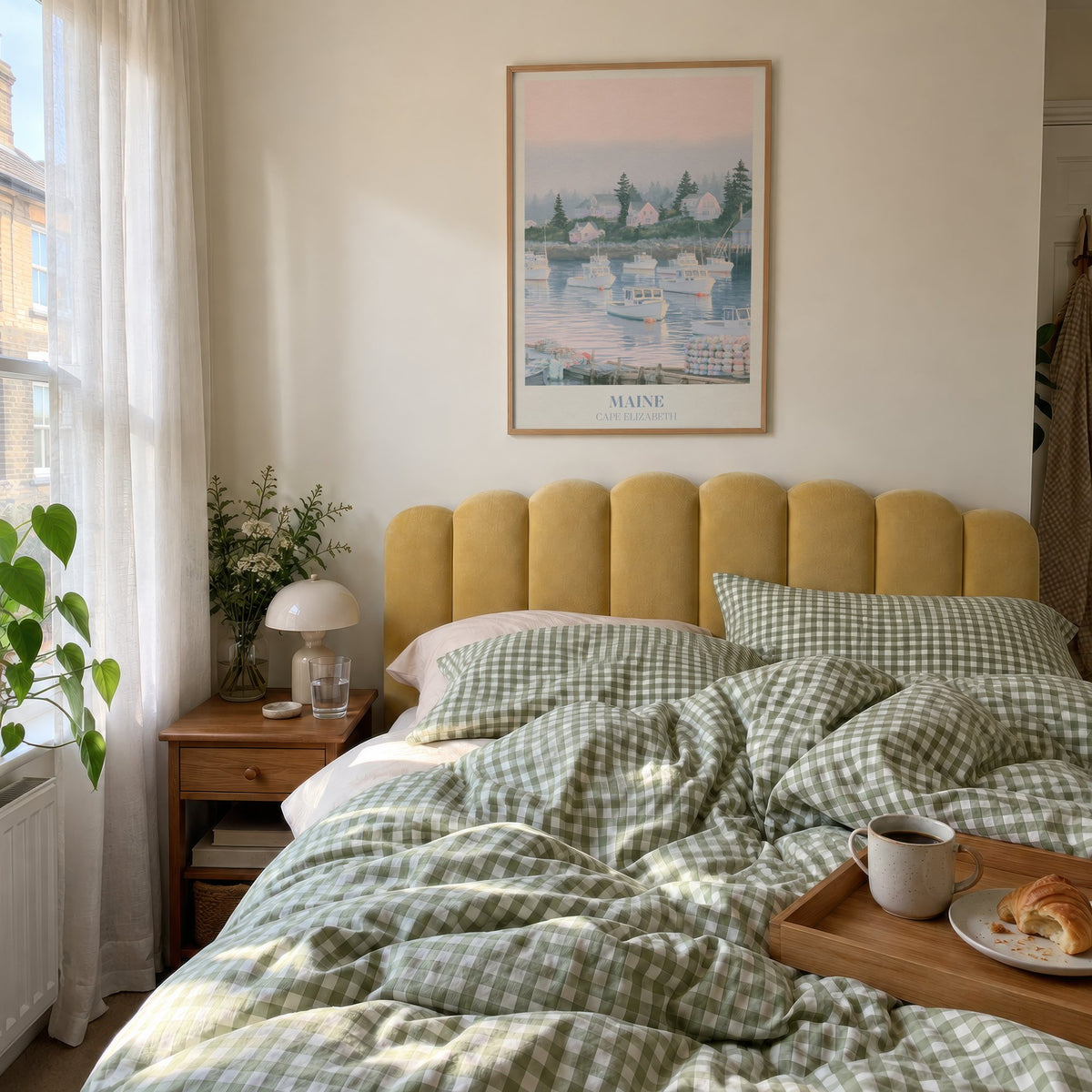 Maine Noah Kahan print of lobster boats in a misty pink harbour, hung above a bed with green gingham bedding