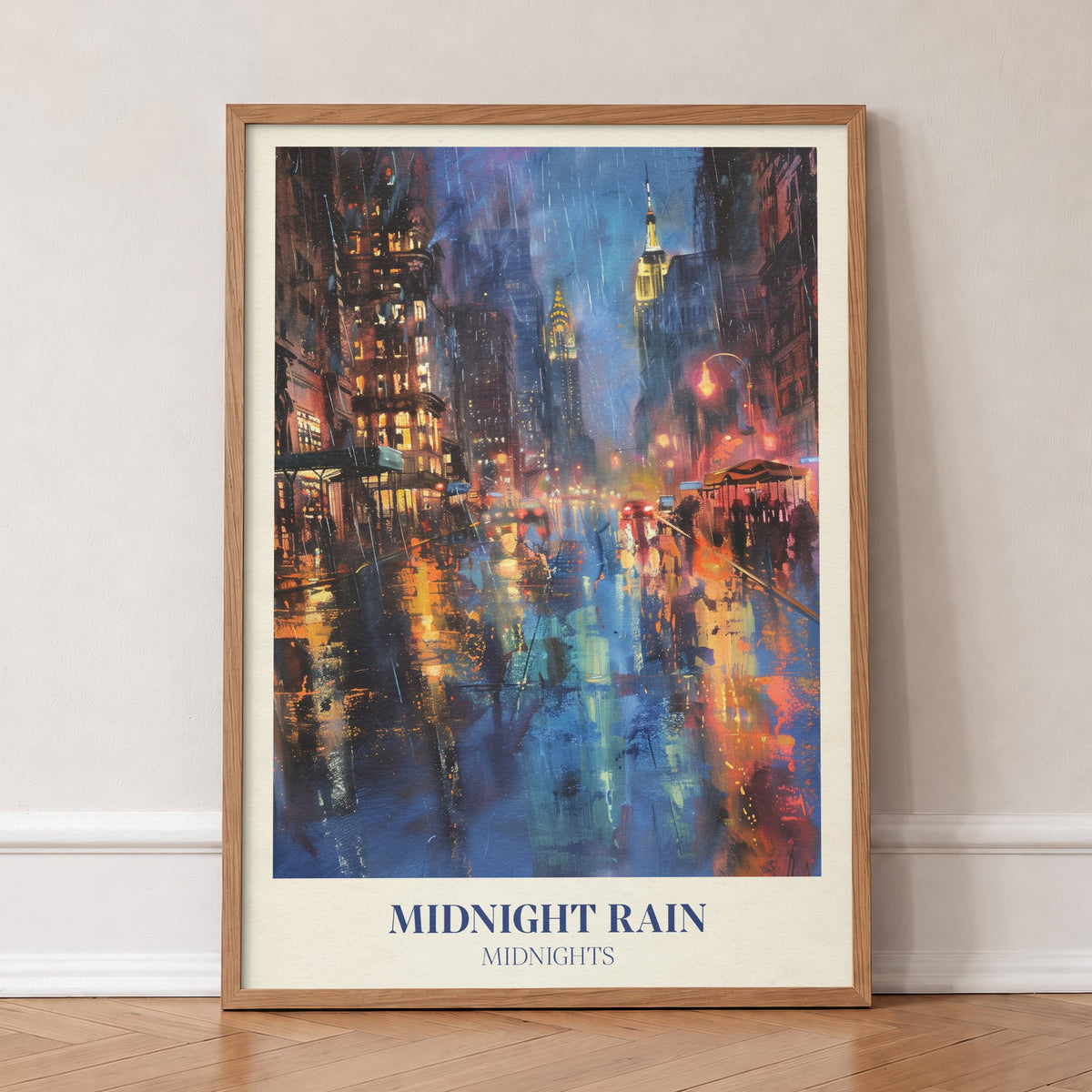 Midnight Rain Taylor Swift print of a rain-soaked city street glowing under skyscrapers at night, in an oak frame, leaning against a wall on a herringbone floor