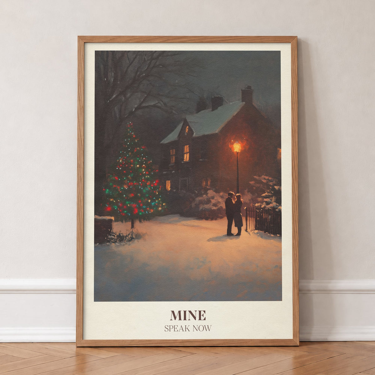 Mine Christmas Taylor Swift print of a couple by a lit Christmas tree in the snow, in an oak frame, leaning against a wall on a herringbone floor