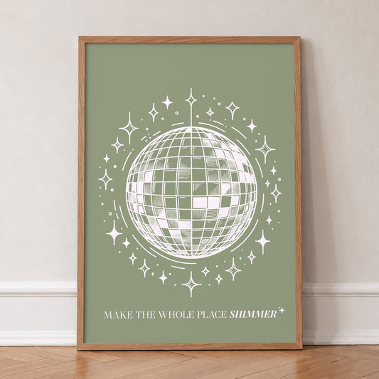 Mirrorball Taylor Swift print of a white line-drawn disco ball on sage green, in an oak frame, leaning against a wall on a herringbone floor