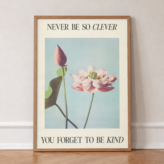 Never Be So Clever Taylor Swift print of a pink lotus on pale blue between lines of lyric, in an oak frame, leaning against a wall on a herringbone floor