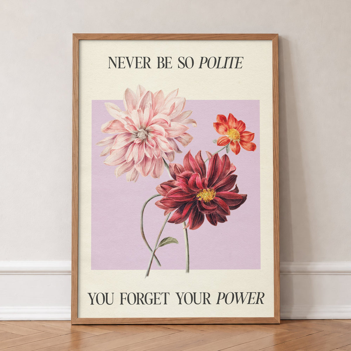 Never Be So Polite Taylor Swift print of pink and red dahlias on lilac between lines of lyric, in an oak frame, leaning against a wall on a herringbone floor