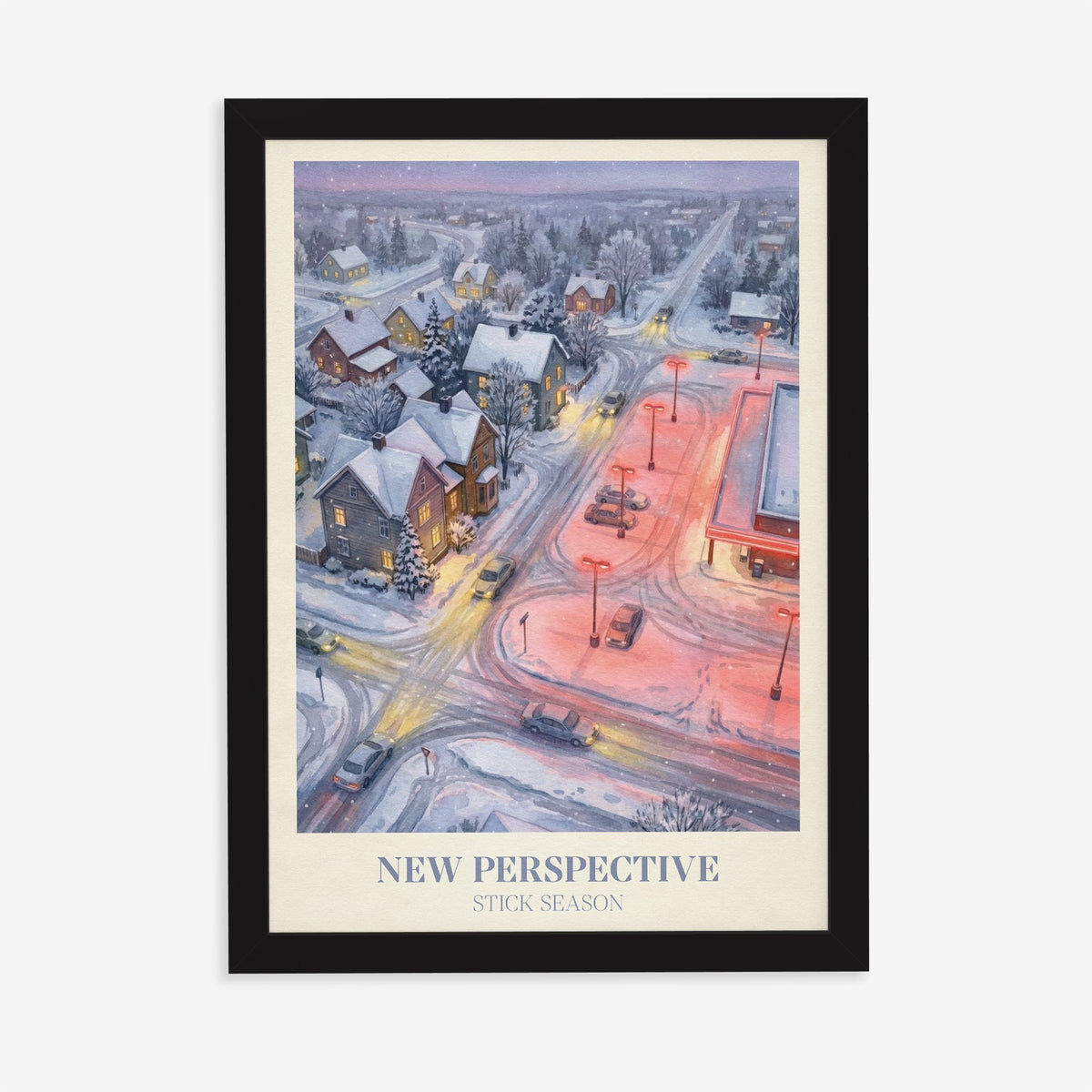 New Perspective Noah Kahan print of a snowy small town at night with a red-lit car park, in a black frame on a plain wall