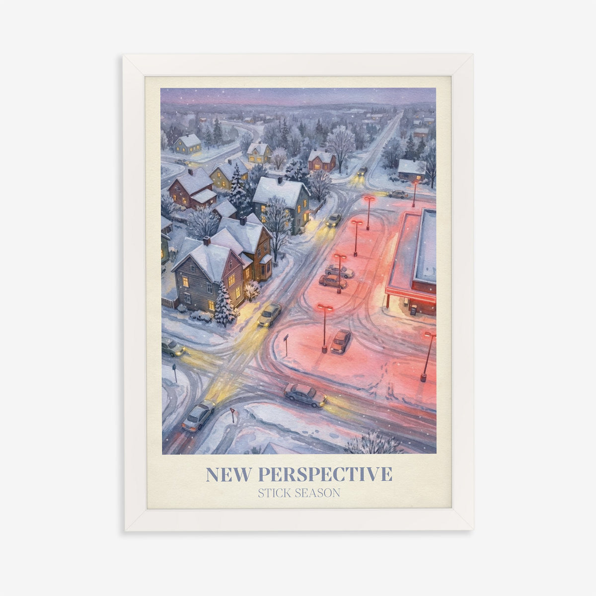 New Perspective Noah Kahan print of a snowy small town at night with a red-lit car park, in a white frame on a plain wall
