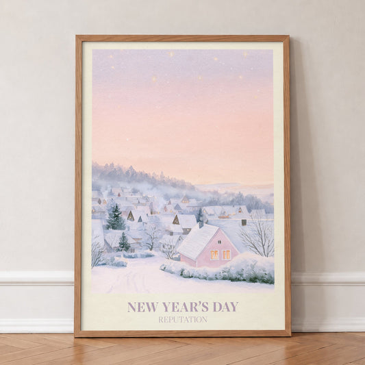New Year’s Day Taylor Swift print of a snowy pink cottage, in an oak frame, leaning against a wall on a herringbone floor