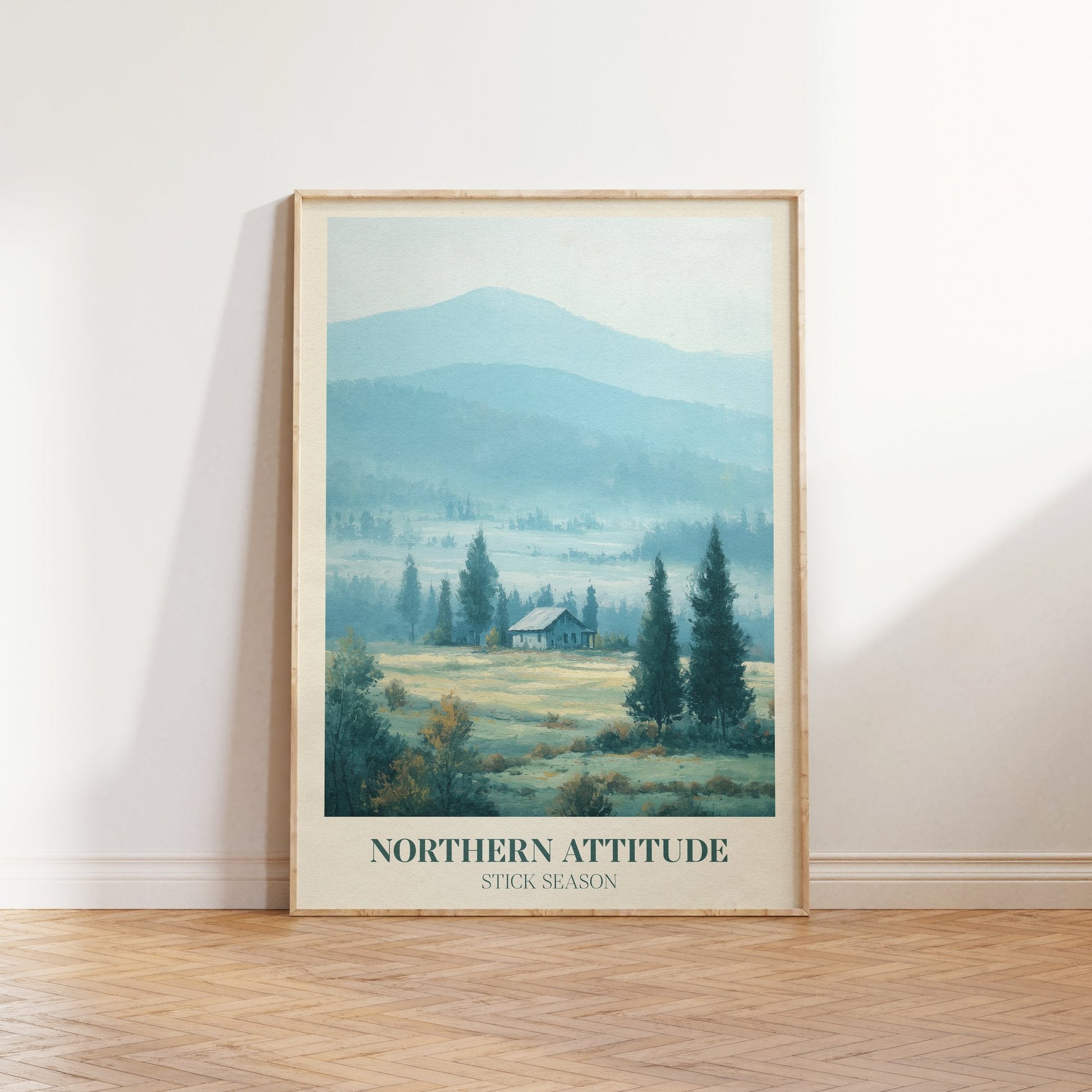 Northern Attitude lyric print inspired by Noah Kahan leaning against a white wall on a wooden herringbone floor in soft daylight