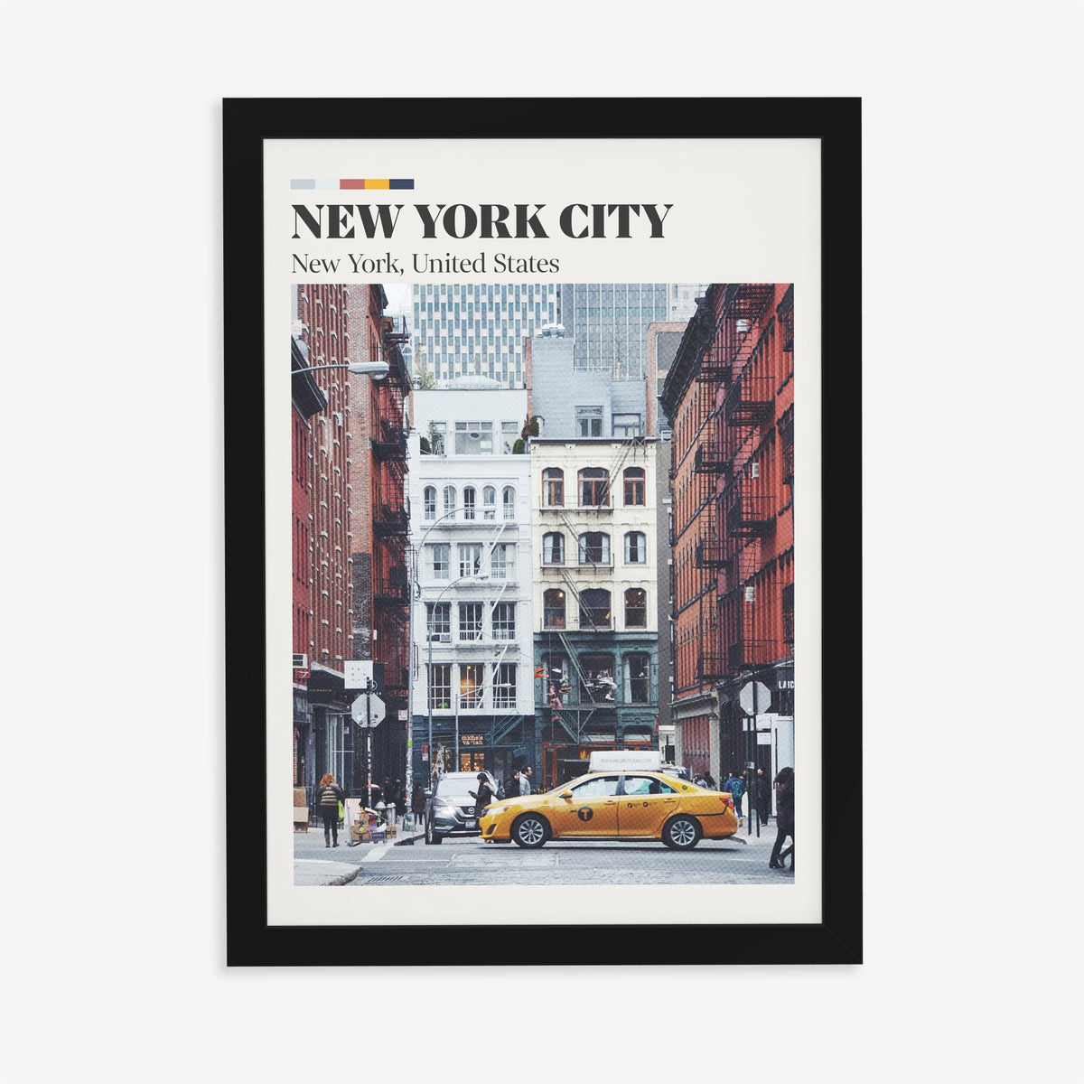 New York City travel print of an old brick street with fire escapes and a yellow taxi, in a black frame on a plain wall