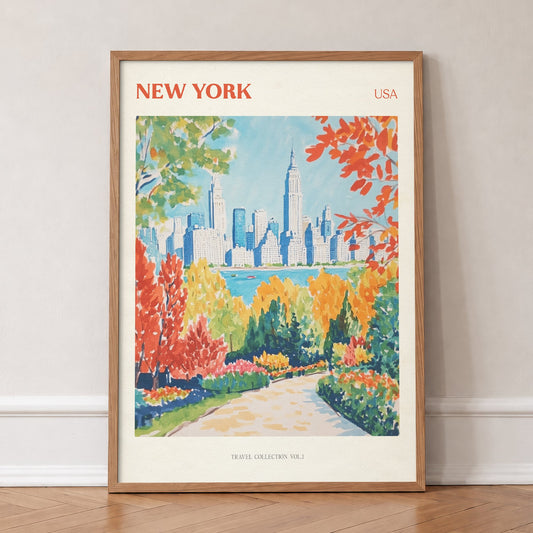 New York travel print of the Manhattan skyline behind bright red and orange trees, in an oak frame, leaning against a wall on a herringbone floor
