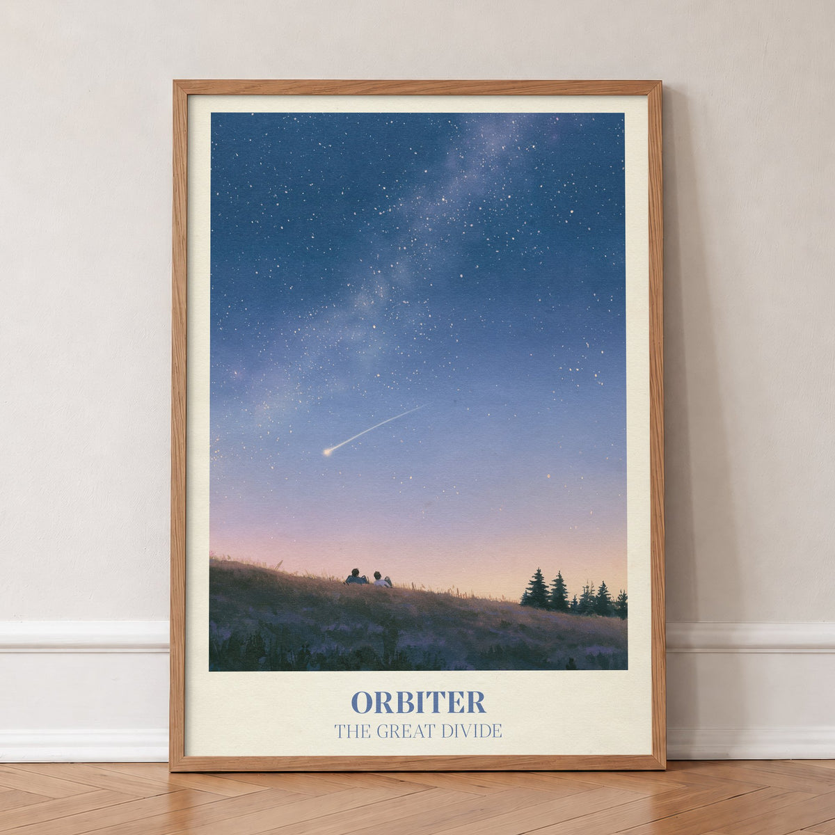 Orbiter Noah Kahan print of two people watching a shooting star from a hillside, in an oak frame, leaning against a wall