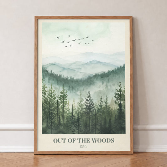 Out Of The Woods Misty Pines Taylor Swift print of a pine forest below misty green hills, in an oak frame, leaning against a wall on a herringbone floor